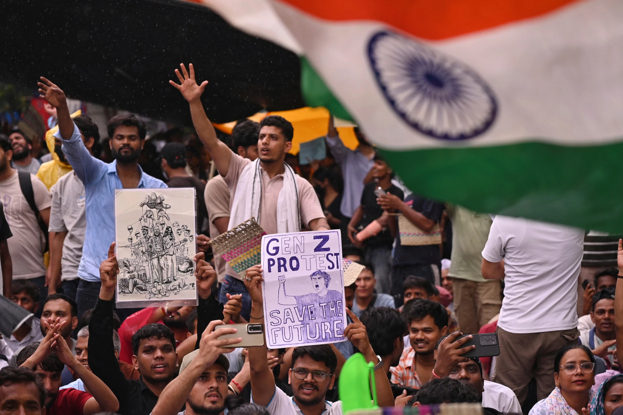 Photo of a crowd of protestors in New Delhi. One holds a sign that reads "GEN Z PROTEST, SAVE THE FUTURE."